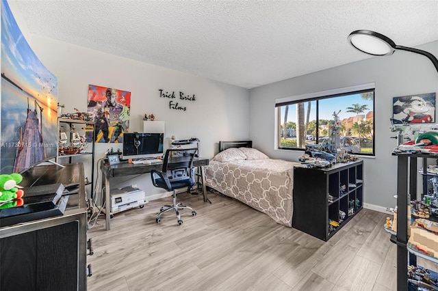 bedroom featuring hardwood / wood-style flooring and a textured ceiling