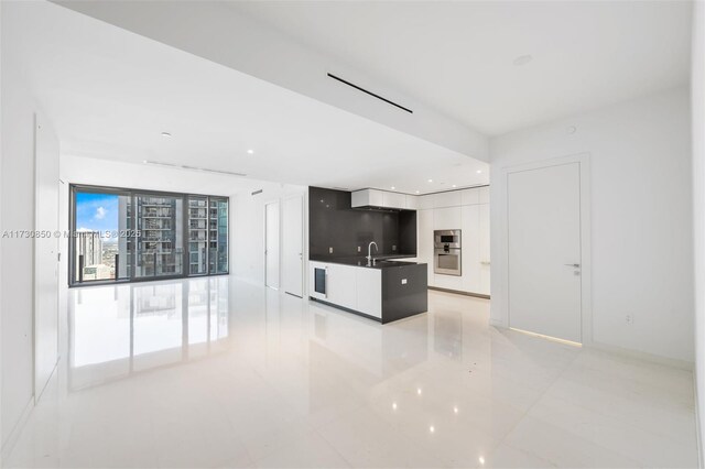 living room with a water view, a healthy amount of sunlight, and a towering ceiling