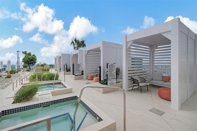 view of swimming pool with a patio area and a hot tub