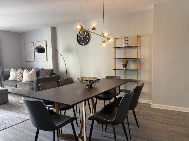 dining room with a notable chandelier, dark hardwood / wood-style flooring, and a textured ceiling