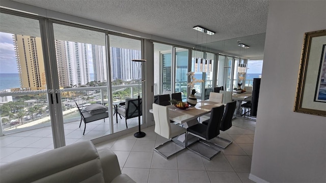 tiled dining area with a wall of windows and a textured ceiling