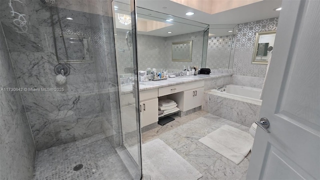 full bath with vanity, a bath, marble finish floor, and a marble finish shower