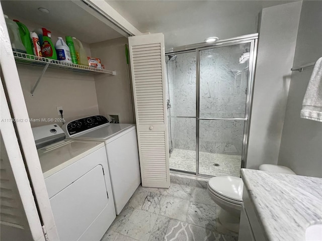 laundry room featuring laundry area, washing machine and dryer, and marble finish floor