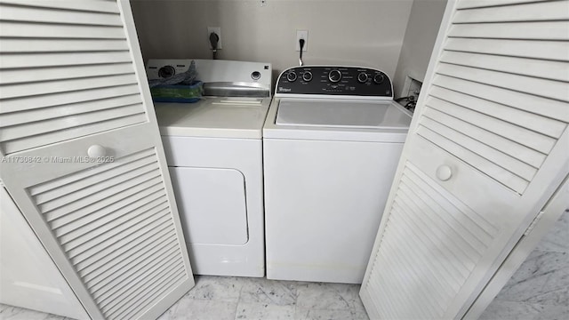 clothes washing area with laundry area, marble finish floor, and independent washer and dryer