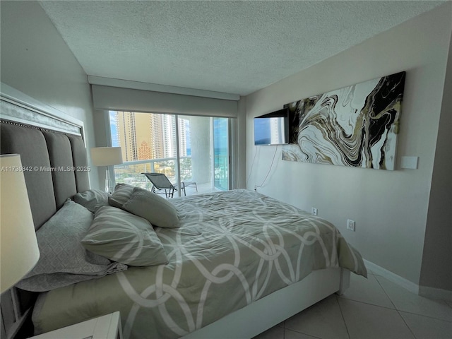 tiled bedroom featuring a textured ceiling