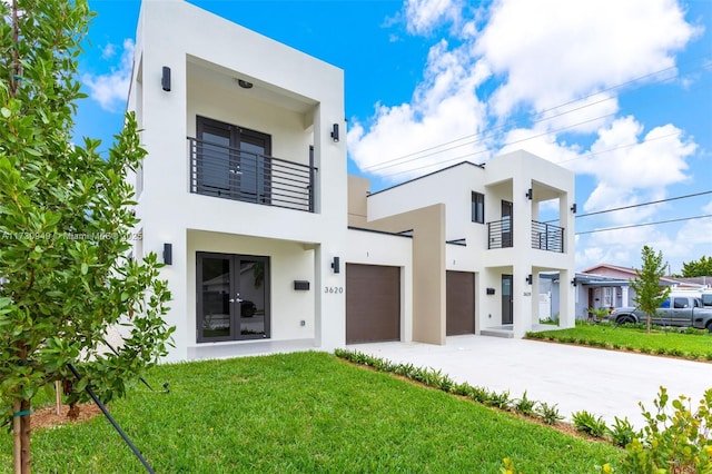 contemporary house featuring french doors, a balcony, and a front lawn