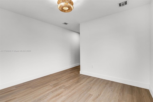 spare room featuring light hardwood / wood-style flooring