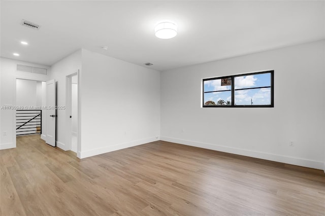 spare room featuring light hardwood / wood-style flooring