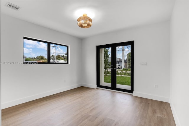 unfurnished room with light wood-type flooring