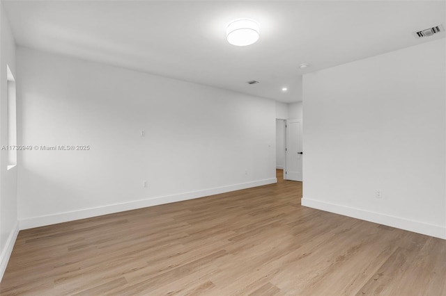 unfurnished room with light wood-type flooring