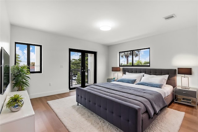 bedroom featuring hardwood / wood-style flooring, access to outside, and french doors