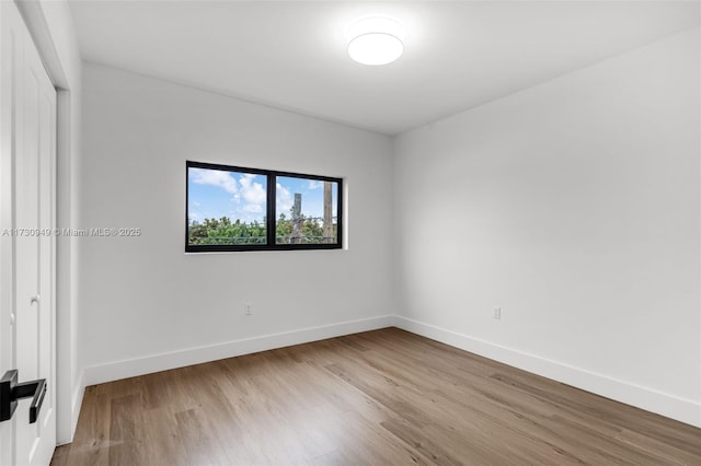 empty room with light hardwood / wood-style flooring