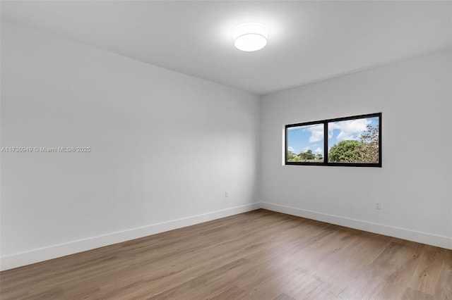 unfurnished room with light hardwood / wood-style floors