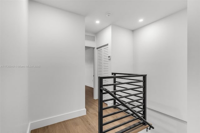 stairs featuring hardwood / wood-style flooring