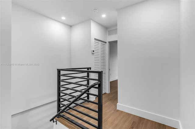 stairs featuring hardwood / wood-style flooring