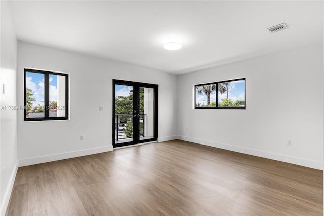 empty room featuring hardwood / wood-style floors and french doors