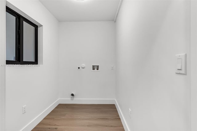 washroom with hookup for a washing machine, light hardwood / wood-style flooring, and electric dryer hookup