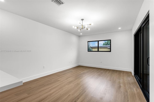 interior space with a notable chandelier and light wood-type flooring