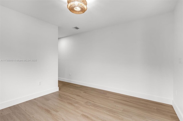 unfurnished room with light wood-type flooring