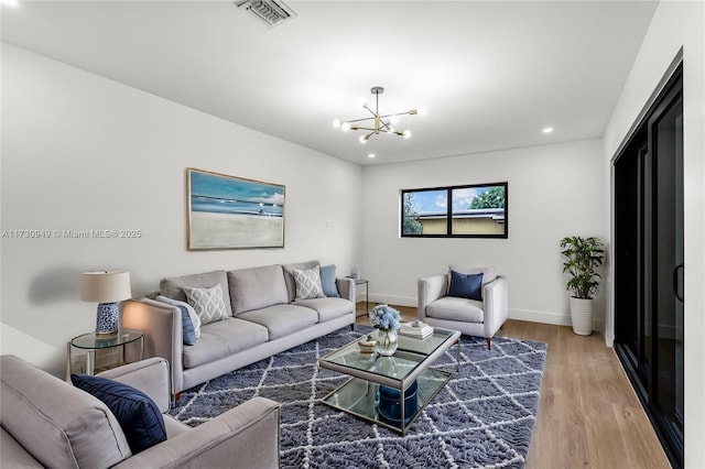 living room featuring wood-type flooring and a chandelier