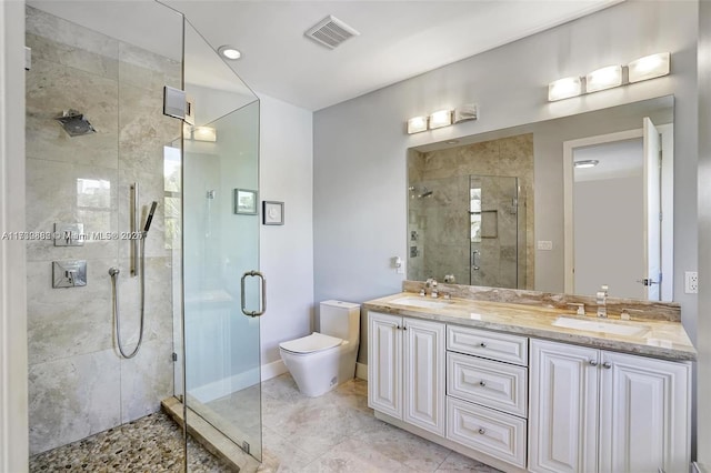 bathroom featuring vanity, toilet, and a shower with door