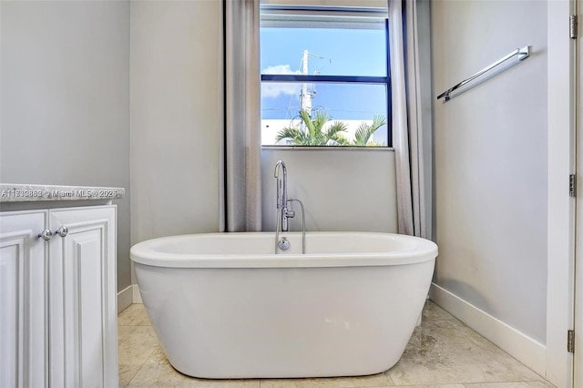 bathroom with a tub to relax in and vanity