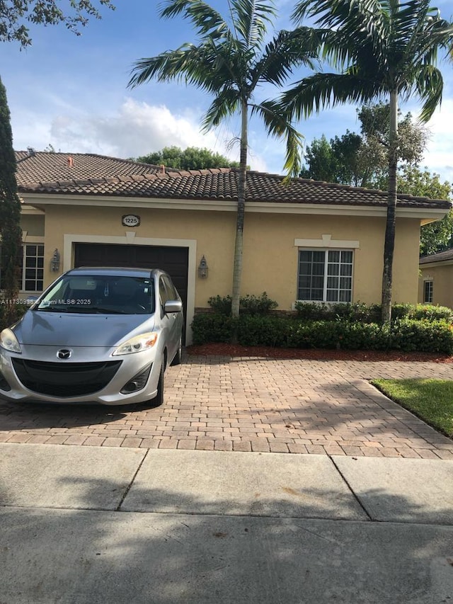 mediterranean / spanish-style home with a garage