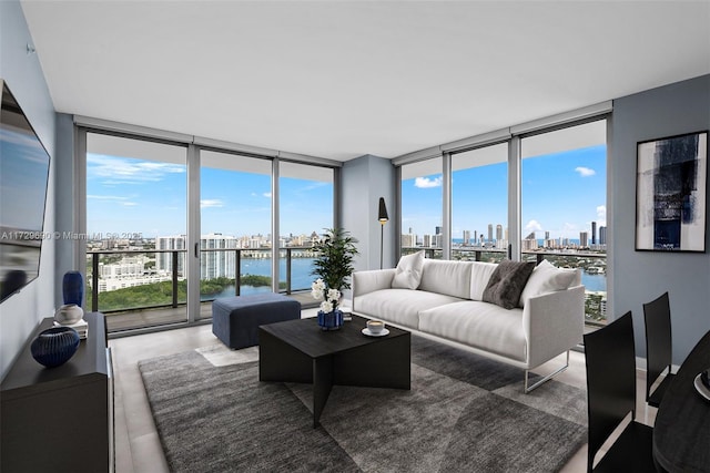 living room featuring a water view, concrete flooring, and floor to ceiling windows