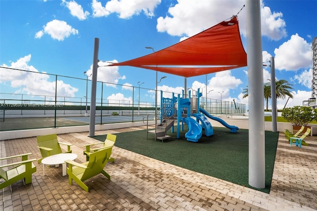 view of jungle gym with tennis court