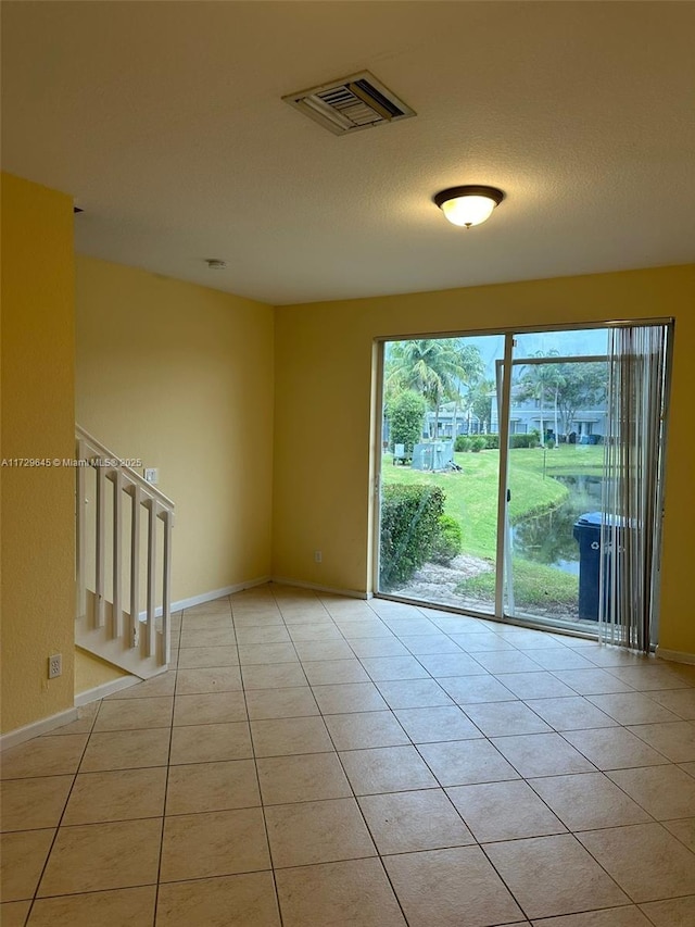 spare room with light tile patterned flooring