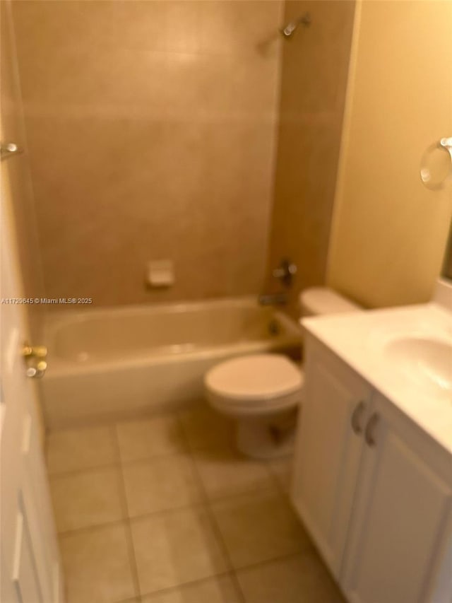 full bathroom with tiled shower / bath combo, toilet, tile patterned flooring, and vanity