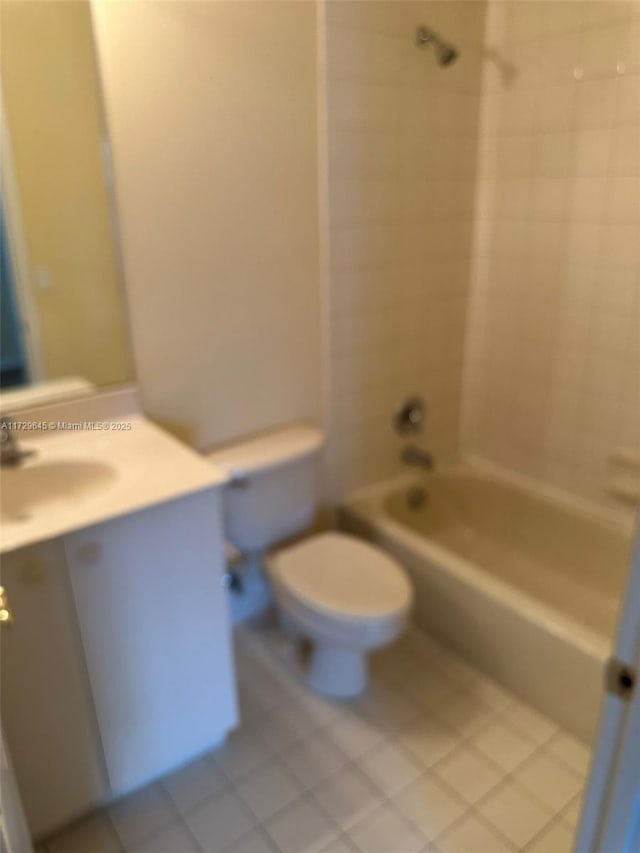 full bathroom with toilet, tiled shower / bath, tile patterned flooring, and vanity