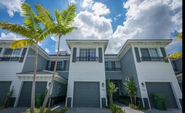 view of front of house featuring a balcony and a garage