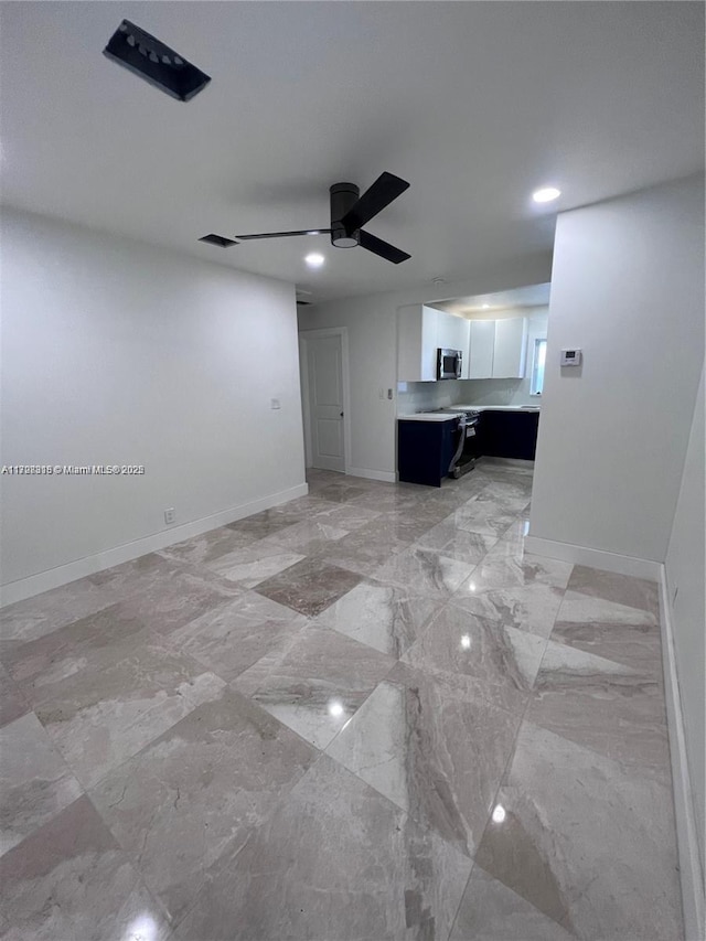 unfurnished living room featuring ceiling fan