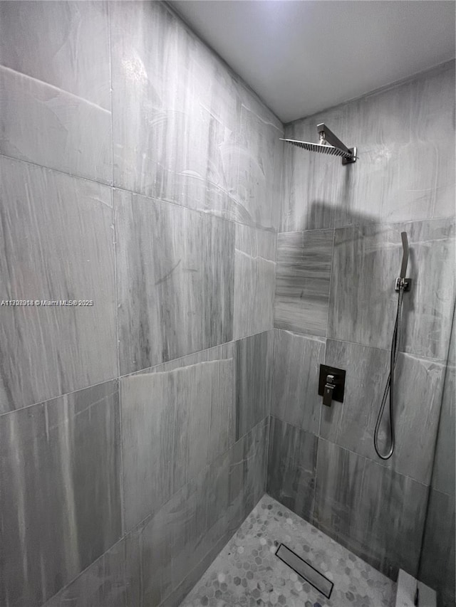 bathroom with tiled shower