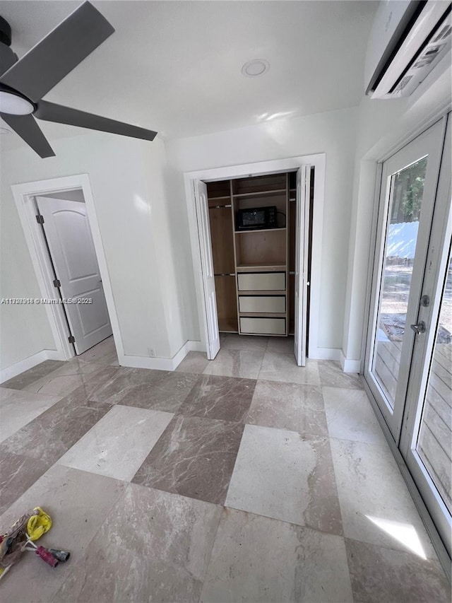 unfurnished room featuring french doors and a wall mounted AC