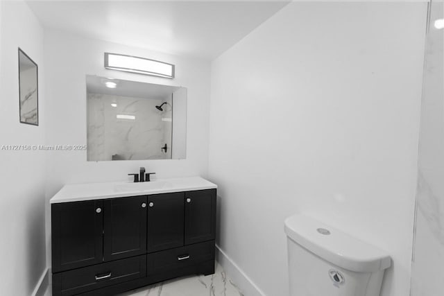 bathroom with toilet, walk in shower, and vanity