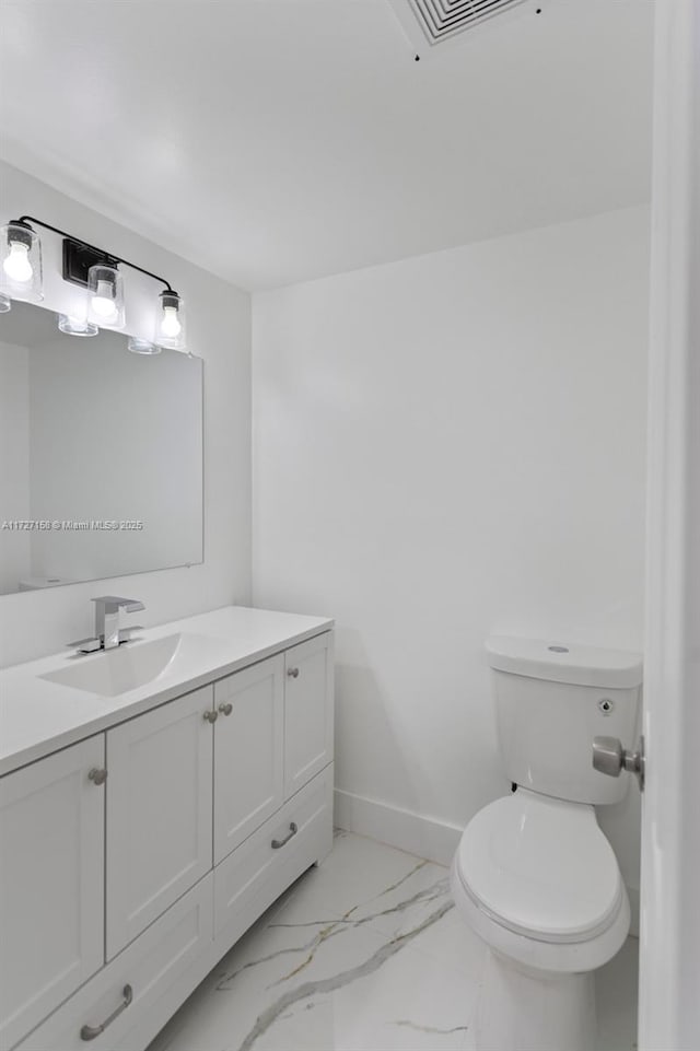 bathroom featuring toilet and vanity