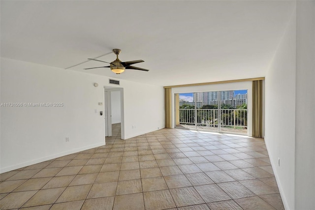 unfurnished room featuring ceiling fan and light tile patterned floors