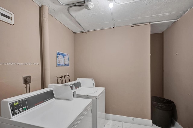 laundry room with light tile patterned floors and washer and dryer