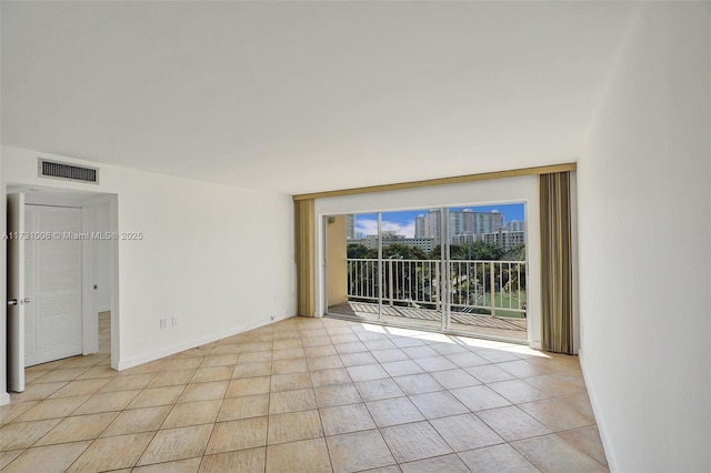 spare room with light tile patterned floors