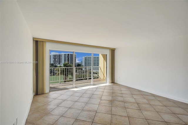 unfurnished room featuring light tile patterned floors and expansive windows