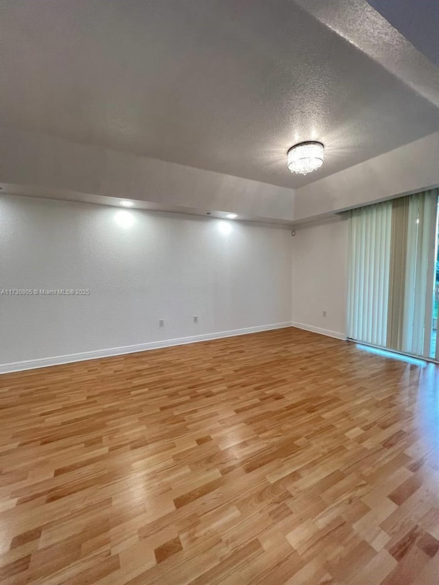 empty room featuring light hardwood / wood-style floors and a textured ceiling