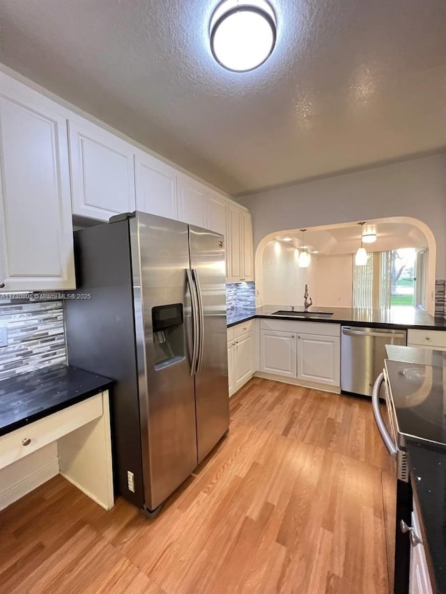 kitchen featuring sink, backsplash, white cabinets, and stainless steel appliances