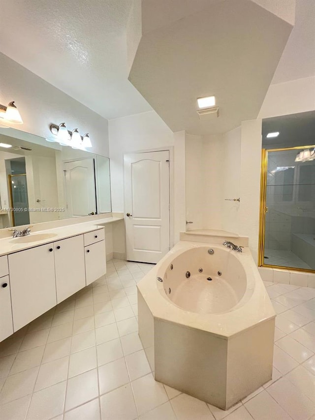 bathroom with tile patterned floors, vanity, and separate shower and tub