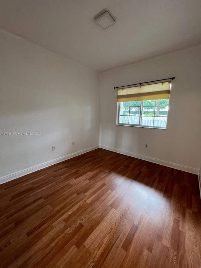 empty room with hardwood / wood-style flooring