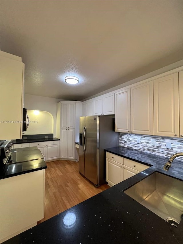 kitchen with sink, light wood-type flooring, white cabinetry, and stainless steel appliances