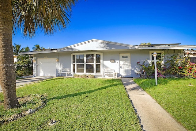 ranch-style home with a front yard and a garage