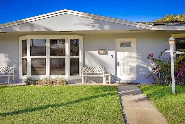 doorway to property with a yard