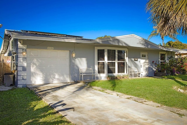 ranch-style home with a garage and a front lawn